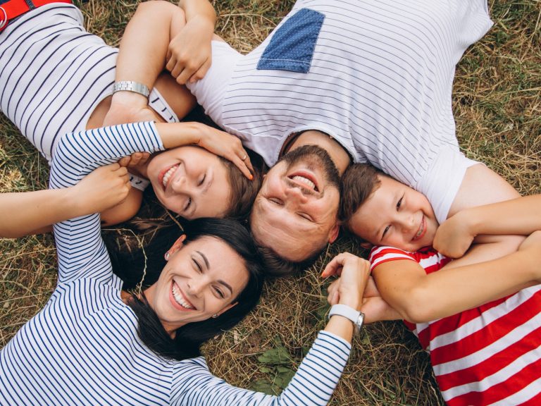 Parents with their children walking in forest