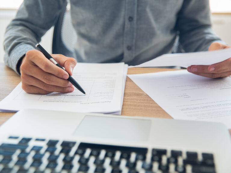 Businessman checking documents at table